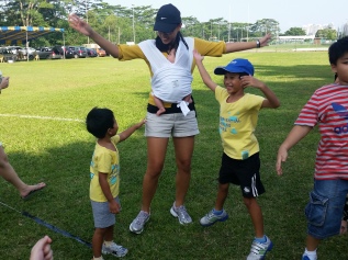 Me faking jumping jacks with the kids at their sports day