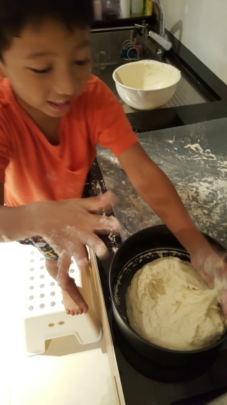 Pressing down the dough in the pan.