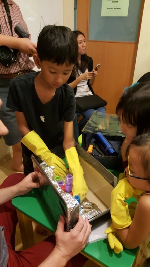 Exploring sensory bins with and without gloves to discover the differences in the experience (Photo credit: The Little Executive)